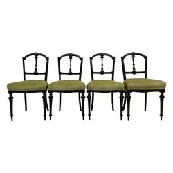 Set of four late Victorian ebonised dining chairs, decorated with carved and gilt foliate decoration, upholstered seats, on turned and fluted front supports 