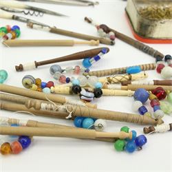 19th century and later lace maker's bone and turned wooden bobbins with glass spangles, pins, patterns, five cushions, related book and other accessories 