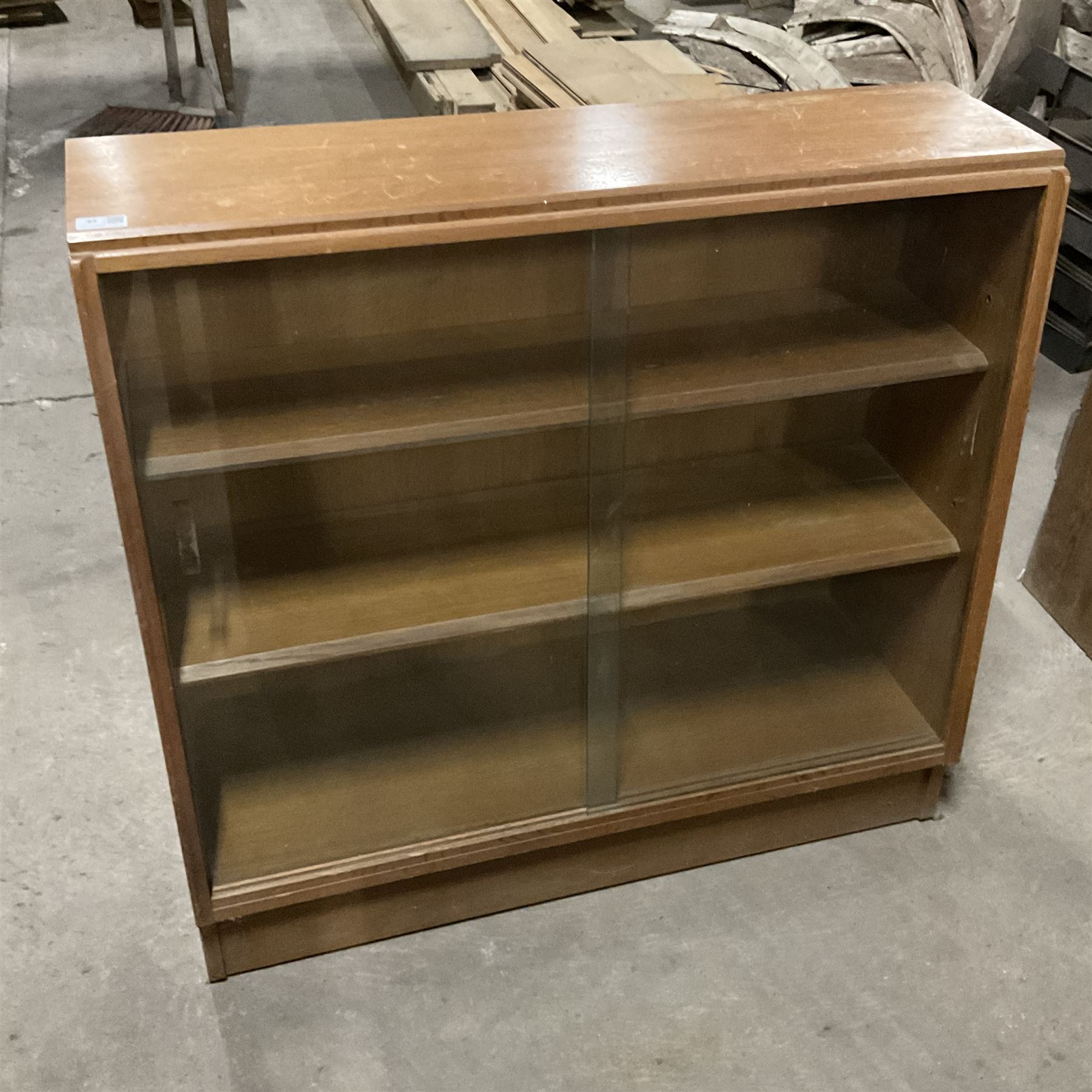 Mid-20th century oak library bookcase, sloped form and fitted with two sliding glass doors - THIS LOT IS TO BE COLLECTED BY APPOINTMENT FROM THE OLD BUFFER DEPOT, MELBOURNE PLACE, SOWERBY, THIRSK, YO7 1QY