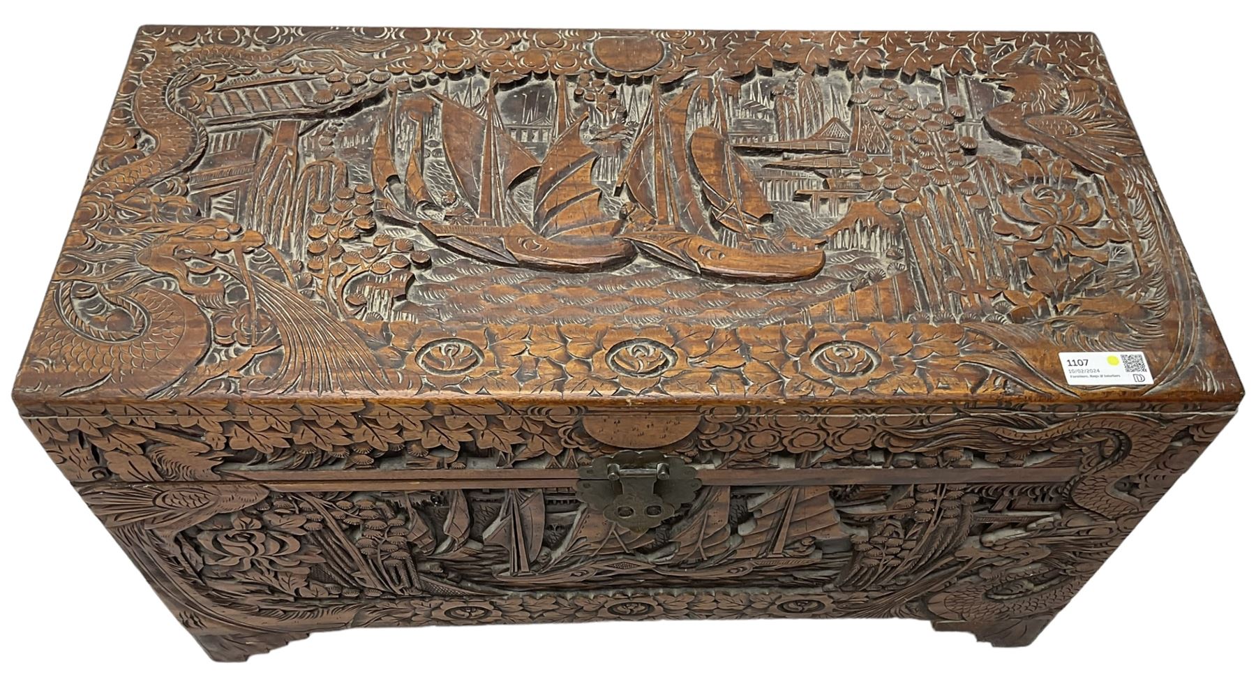 Chinese carved camphor wood blanked chest, rectangular hinged top, carved all over with traditional dragon motifs and junk ships