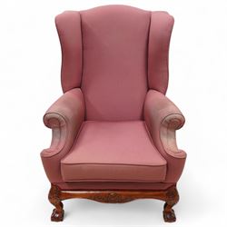 Georgian design mahogany framed wingback armchair, upholstered in rouge fabric, on ball an...