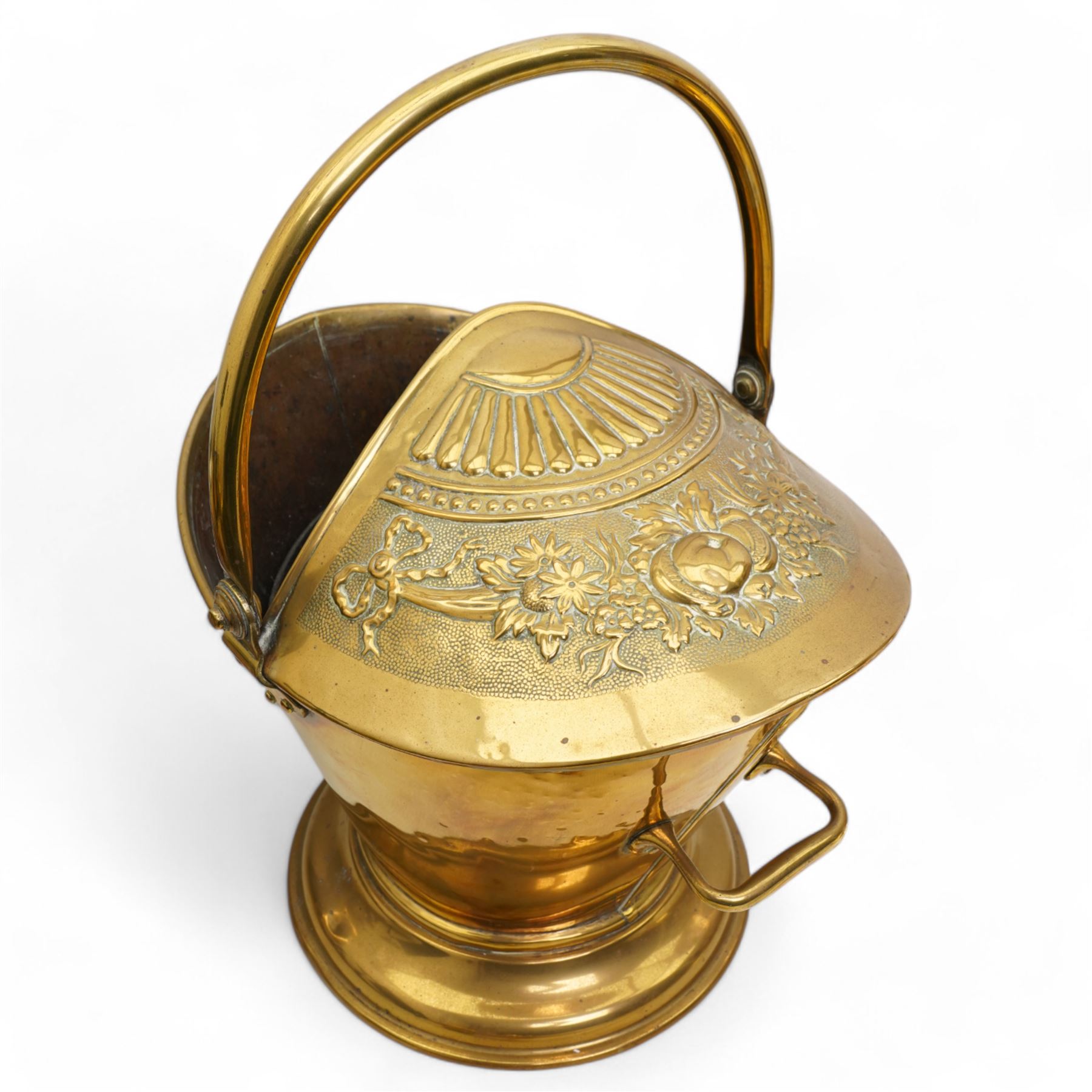 Victorian brass helmet shaped coal scuttle, with embossed fruit and foliate decoration, H47cm; with a collection of tools and tool rests, including a poker, shovel and tongs