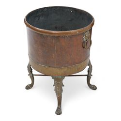 19th century copper and brass log basket, fitted with twin lion mask handles, raised on acanthus cast cabriole supports terminating to paw feet, united by X-stretcher