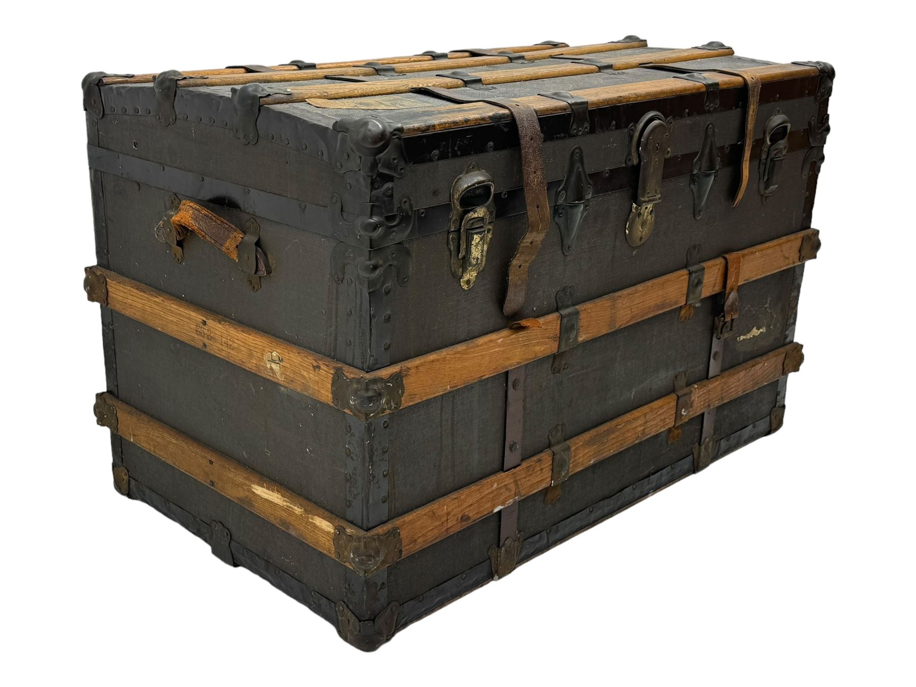 Early 20th century 'McBrine Baggage' steamer trunk, oak frame and black canvas covering, featuring metal hardware and leather straps, fitted with central lock, additional latches, and corner protectors, the interior is lined with floral-patterned paper and includes a removable top tray with makers label 