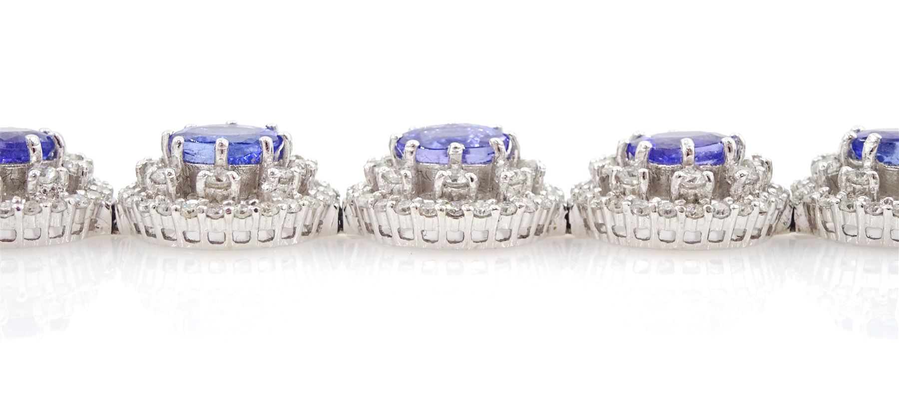 18ct white gold tanzanite and diamond bracelet, twelve oval link clusters set with oval cut tanzanite's and round brilliant cut diamonds, stamped 750, total tanzanite weight approx 11.00 carat, total diamond weight approx 3.65 carat