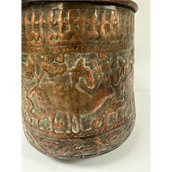 Middle eastern copper bucket, with chased and embossed band of animal decoration, together with a copper jardinière embossed with floral panels, copper plate with embossed leaf motif and two brass helmet shaped coal scuttles, bucket H26cm