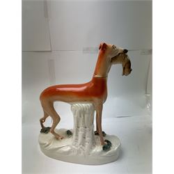 Pair of standing Staffordshire whippets with rabbits in their mouths, together with a pair of Staffordshire spaniels, whippets H30cm