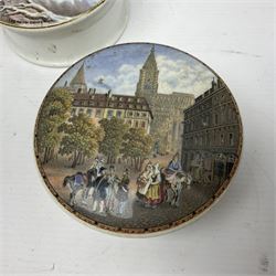 Seven 19th century Prattware pot lids with associated bases, including 'The Snow Drift', 'Strathfieldsaye The Seat of the Duke of Wellington', 'The Late Prince Consort', 'French Street Scene', Lend a Bite', 'Dr Johnson' and 'Sandringham the Seat of HRH The Prince of Wales', largest D12cm (7)