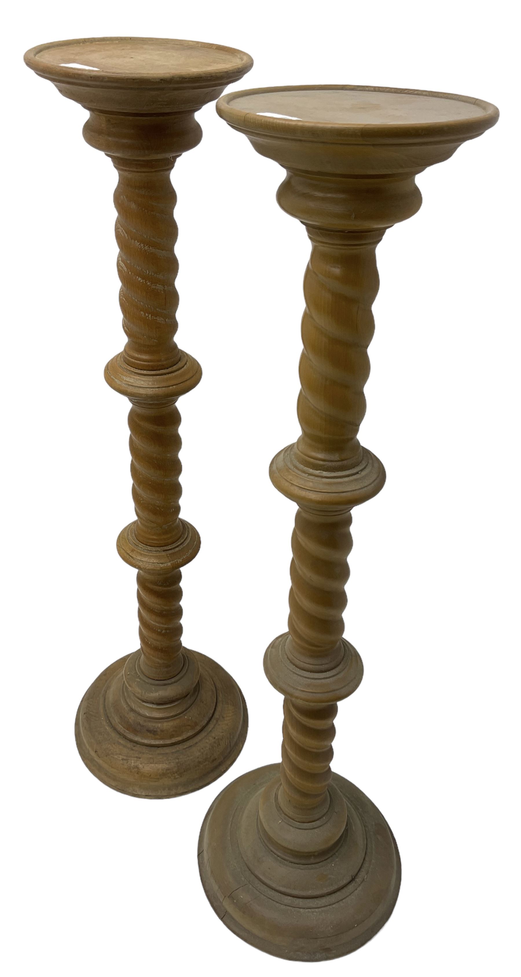 Pair of Victorian design light oak torcheres or jardinieres, circular top with raised lip over a spiral turned column terminating in circular turned plinth base