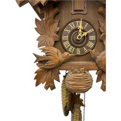 German 1960's cuckoo clock with automata - traditional styled case and dial with a cuckoo sounding the hours and half-hours, twin chain driven movement and automata feature of two carved cuckoos to the front of the case simultaneously moving as the hours are struck. With weights and pendulum.  