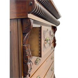 Late Victorian walnut Scotch chest, projecting cornice with turned quarter column mounts over matching half column to frieze, fitted with two upper short drawers with central cupboard, bevelled mirror glazed cupboard door, four graduating drawers below, foliage and flower head carved brackets to the uprights, panelled sides, chamfered plinth on turned feet