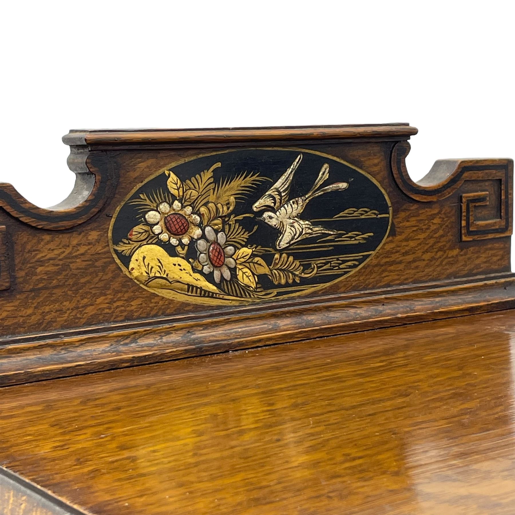 Early 20th century circa. 1920s oak bedside cupboard, raised back decorated with chinoiserie lacquer work depicting bird and flowers, moulded top over single door decorated with figure carrying bird cages, on turned supports united by shaped moulded stretchers, scroll carved feet