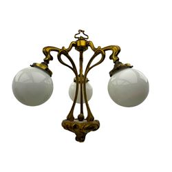 Pair of Art Nouveau design gilt metal ceiling lights, each with three stems connecting glass dome