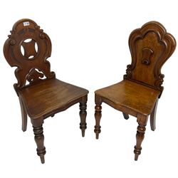 19th century mahogany hall chair, pierced and carved shaped back decorated with C-scrolls, solid seat raised on turned supports (W46cm H88cm); together with another similar (W41cm H87cm)