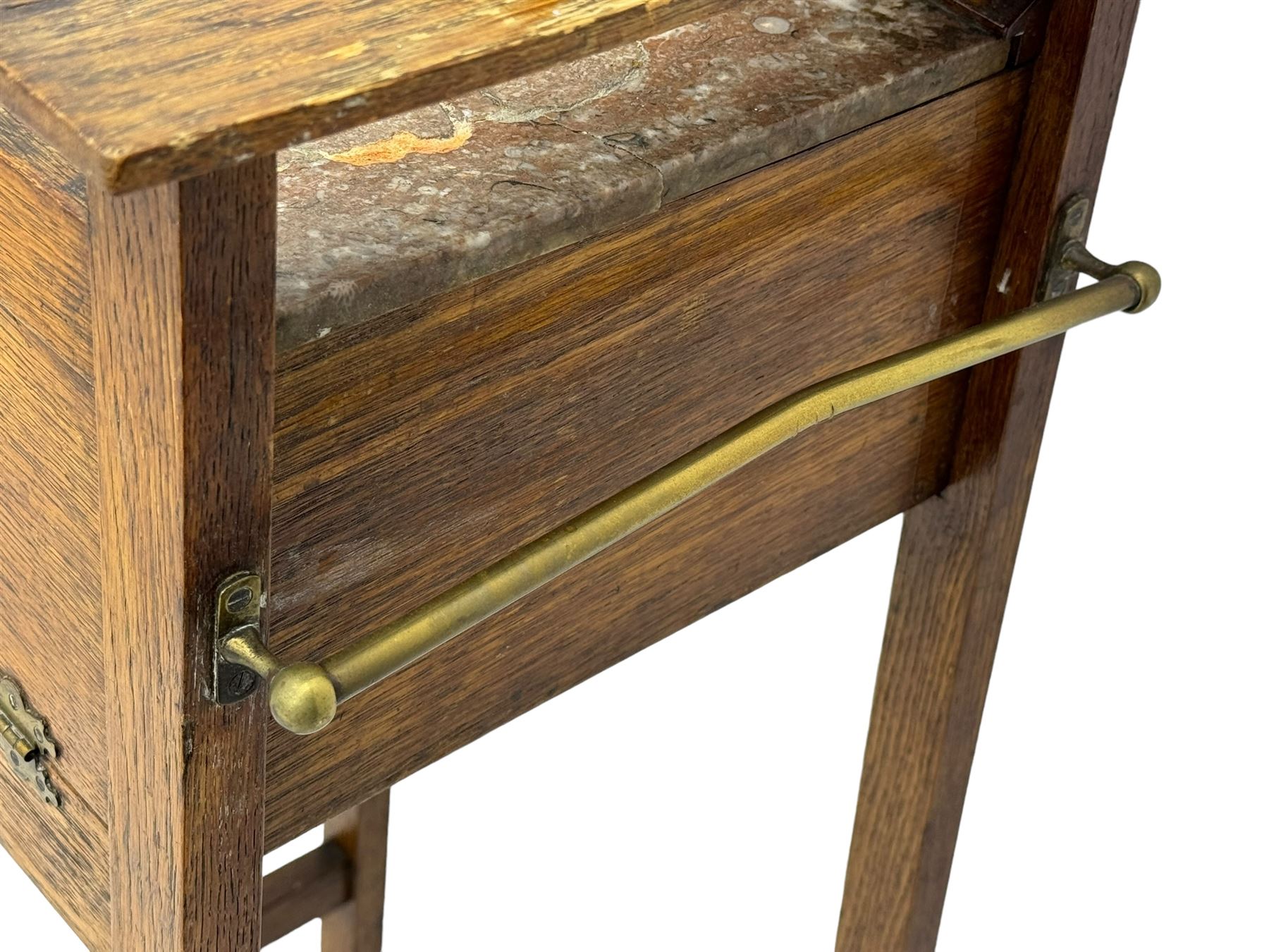 Early 20th century oak vanity stand, with circular adjustable mirror, brass towel rails to the sides, marble inset top and upper compartment, over additional storage compartment with hinged front, on splayed supports with stretchers