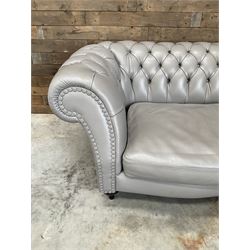 Three seat Chesterfield sofa, upholstered in grey buttoned leather - damaged leg