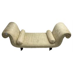 Victorian mahogany framed window seat day bed, the scrolled arms and seat upholstered in ivory foliate patterned damask fabric with matching ropetwist piping, raised on turned supports with castors