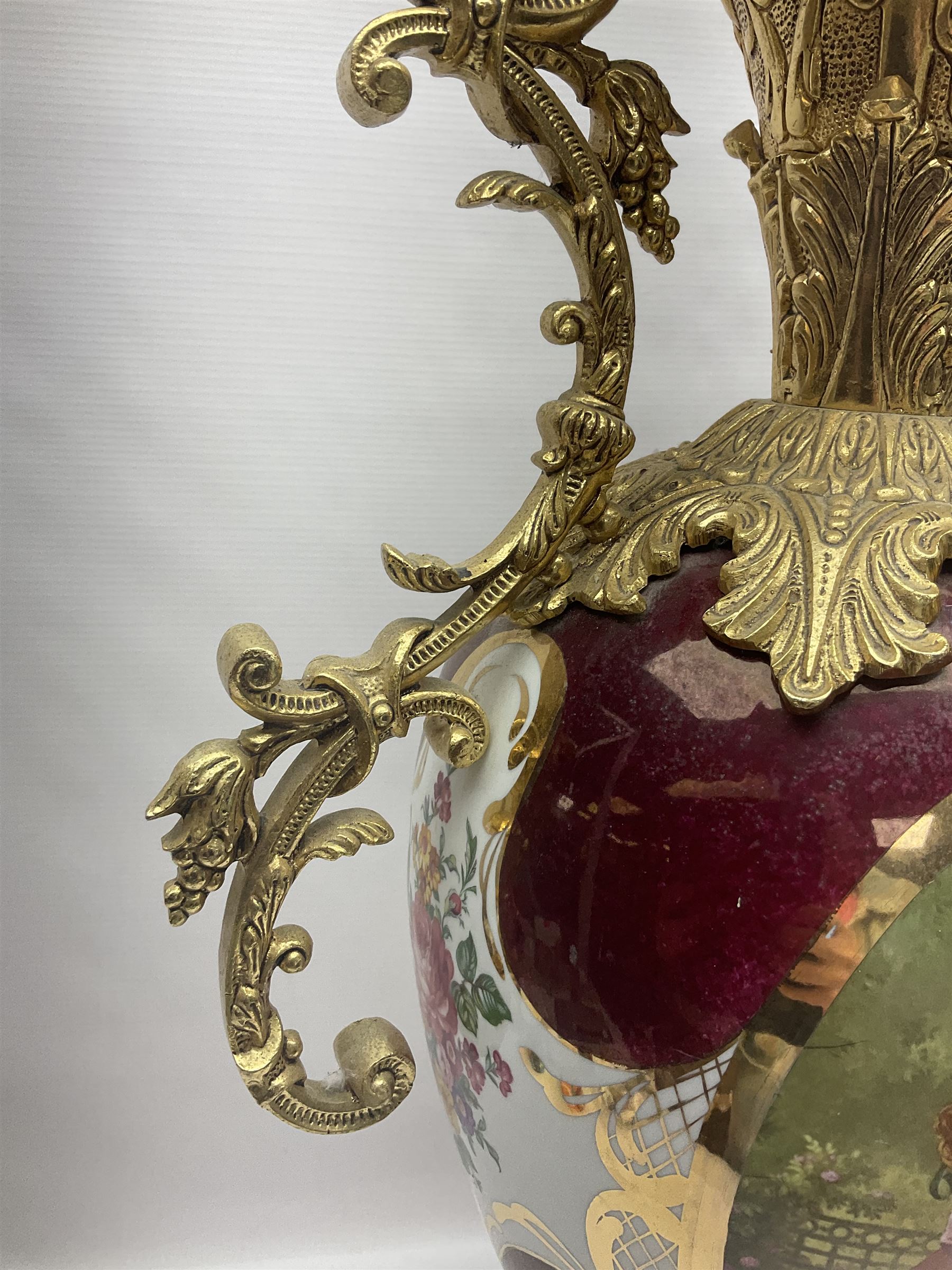 Twin handled vase, the ceramic urn form body decorated with floral sprigs and figural panel, the metal handles designed as vines, together with a similar ewer, vase H75cm 