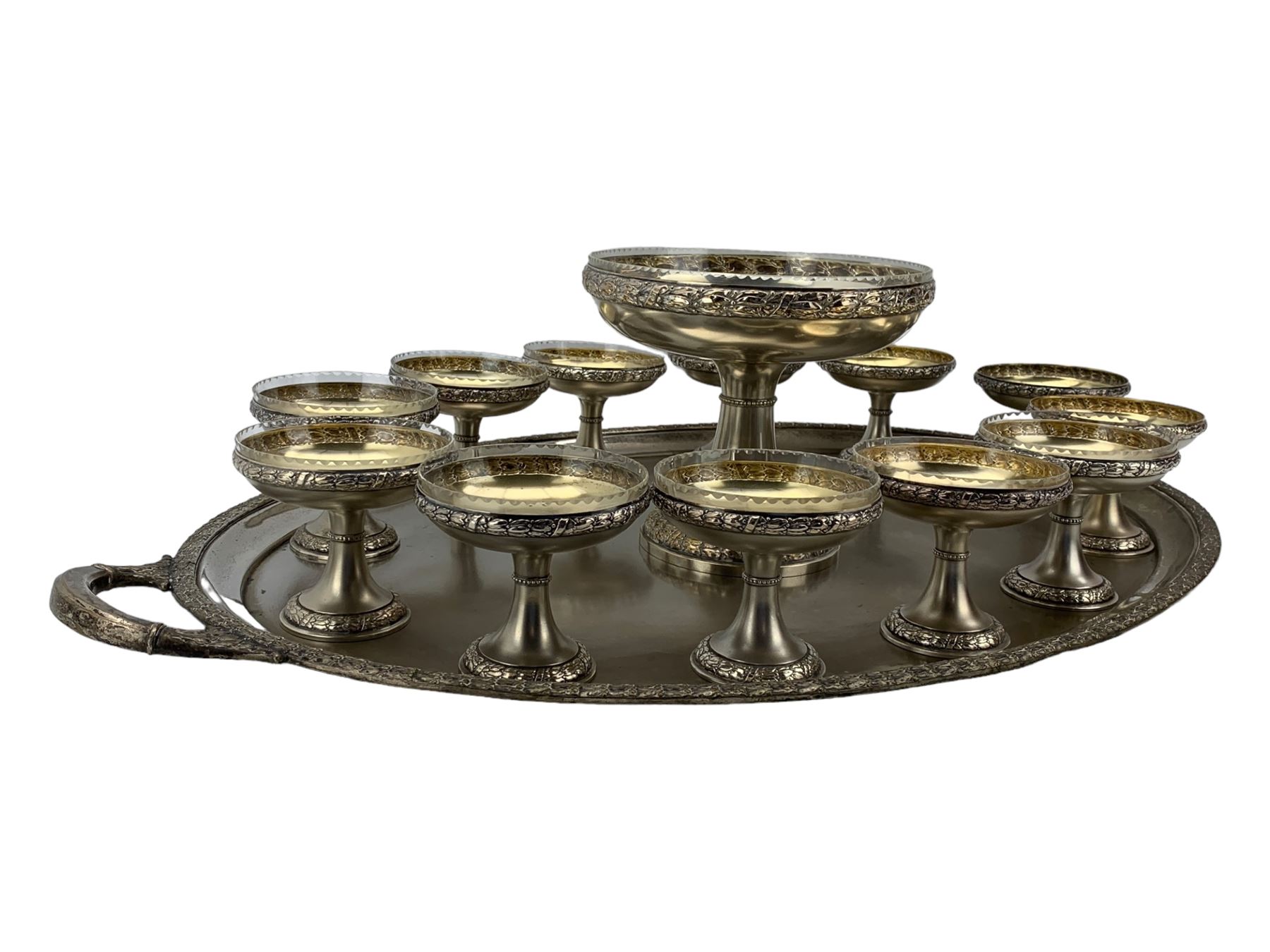 Early 20th century German silver-plated dessert service, comprising a tall comport with clear glass liner, and twelve pedestal bowls, eight with glass liners, with makers mark for Bibus Frantisek & Sohn, on a matching twin handled tray, unmarked, L82cm 