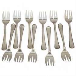 Set of twelve Dutch silver fish knives and eleven forks with reeded edge with Minerva Head duty mark and The Hague assay