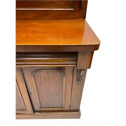 Victorian mahogany chiffonier, raised back with carved C-scroll foliage mounts and shelf, rectangular top with rounded corners over frieze drawer and double panelled cupboard, on skirted base