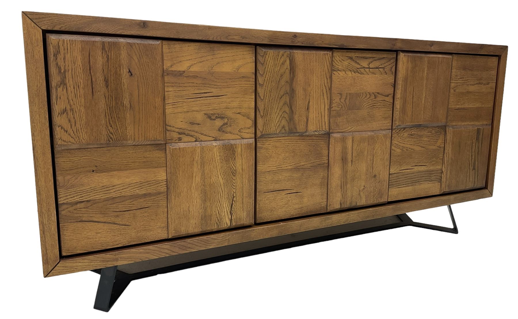 Samba 'Camden' oak sideboard, rectangular top over three block panelled cupboard doors, raised on angled black metal supports connected with stretcher