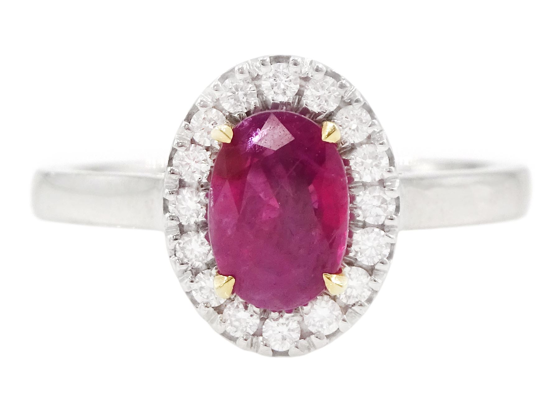 18ct white gold oval cut ruby and round brilliant cut diamond cluster ring, hallmarked, ruby approx 0.85 carat, total diamond weight approx 0.15 carat