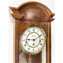 Comitti,  London - 20th century 8-day chiming wall clock in a walnut case, with a moulded break-arch top and full length glazed door and side panels, two part enamel dial with spade hands and visible gridiron pendulum, three train spring driven movement chiming the quarters on 5 gong rods.