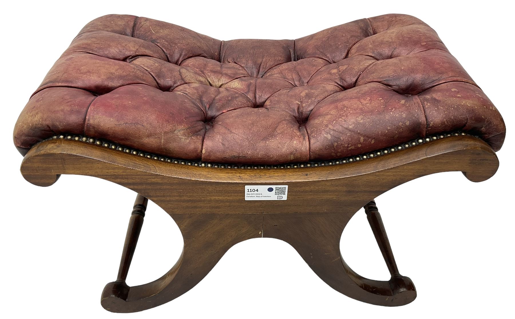 Late 20th century mahogany curved x-framed footstool, upholstered in buttoned red leather, splayed supports united by turned stretchers 