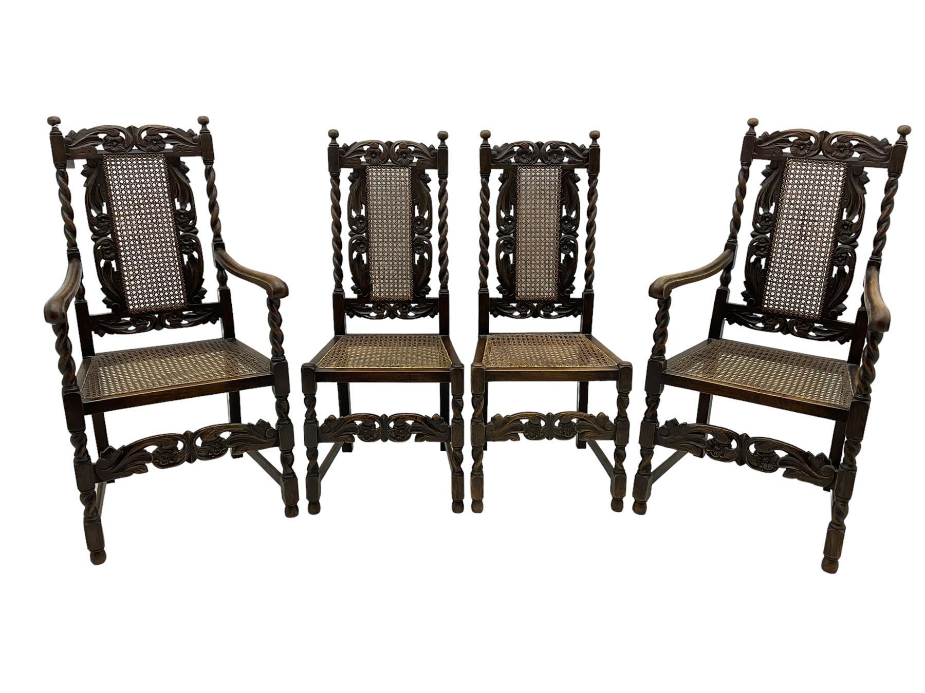 Set of seven (5+2) 19th century Carolean design oak dining chairs, scroll leaf and flower head carved cresting rail over spiral turned uprights and cane work back, the cane work seat on spiral turned supports united by plain stretchers, scrolled leaf carved middle rail 