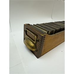 Collection of magic lantern slides, predominantly depicting views of India, with scenes including including the Taj Mahal, tombs, monuments, street scenes, people and animals, in compartmentalised wooden case 