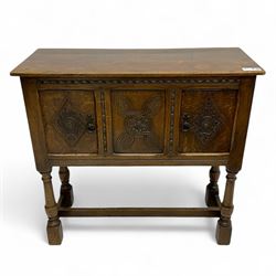 Jacobean design oak cupboard, rectangular top over two doors and central panel, carved wit...