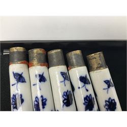 Collection of 18th century blue and white porcelain pistol grip knife hafts, possibly Worcester, comprising set of twenty one decorated in the same pattern with floral sprays and butterflies, with gilt mounts, and a further three with varied decoration of flowers and insects, each approximately L10cm
