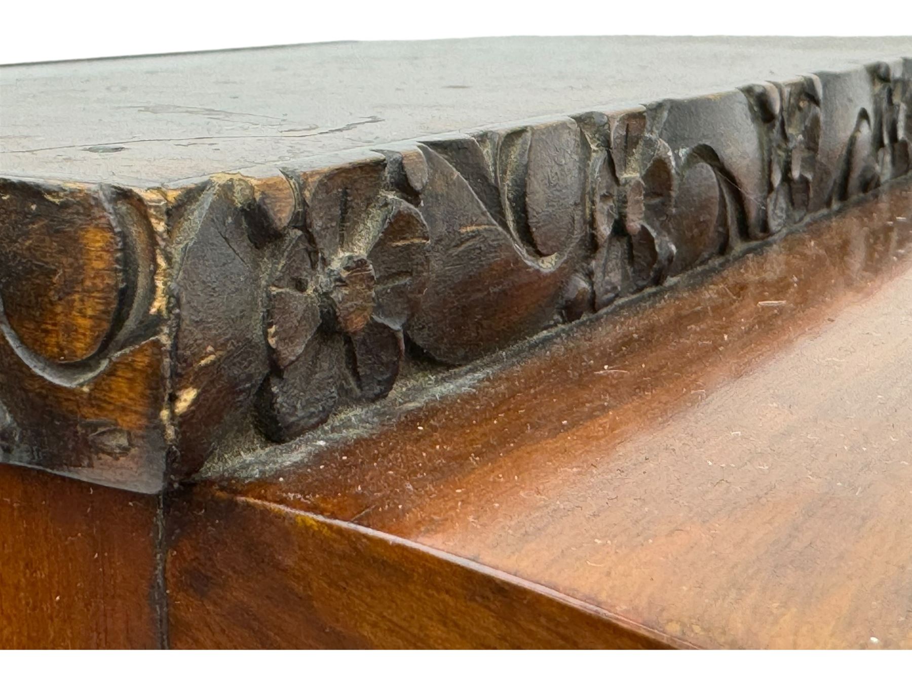 Early 20th century Art Deco walnut display cabinet, with arched top and carved floral crest, central band flanked by two glazed panel doors with decorative mullions, enclosing two glass shelves, on scroll carved bracket feet