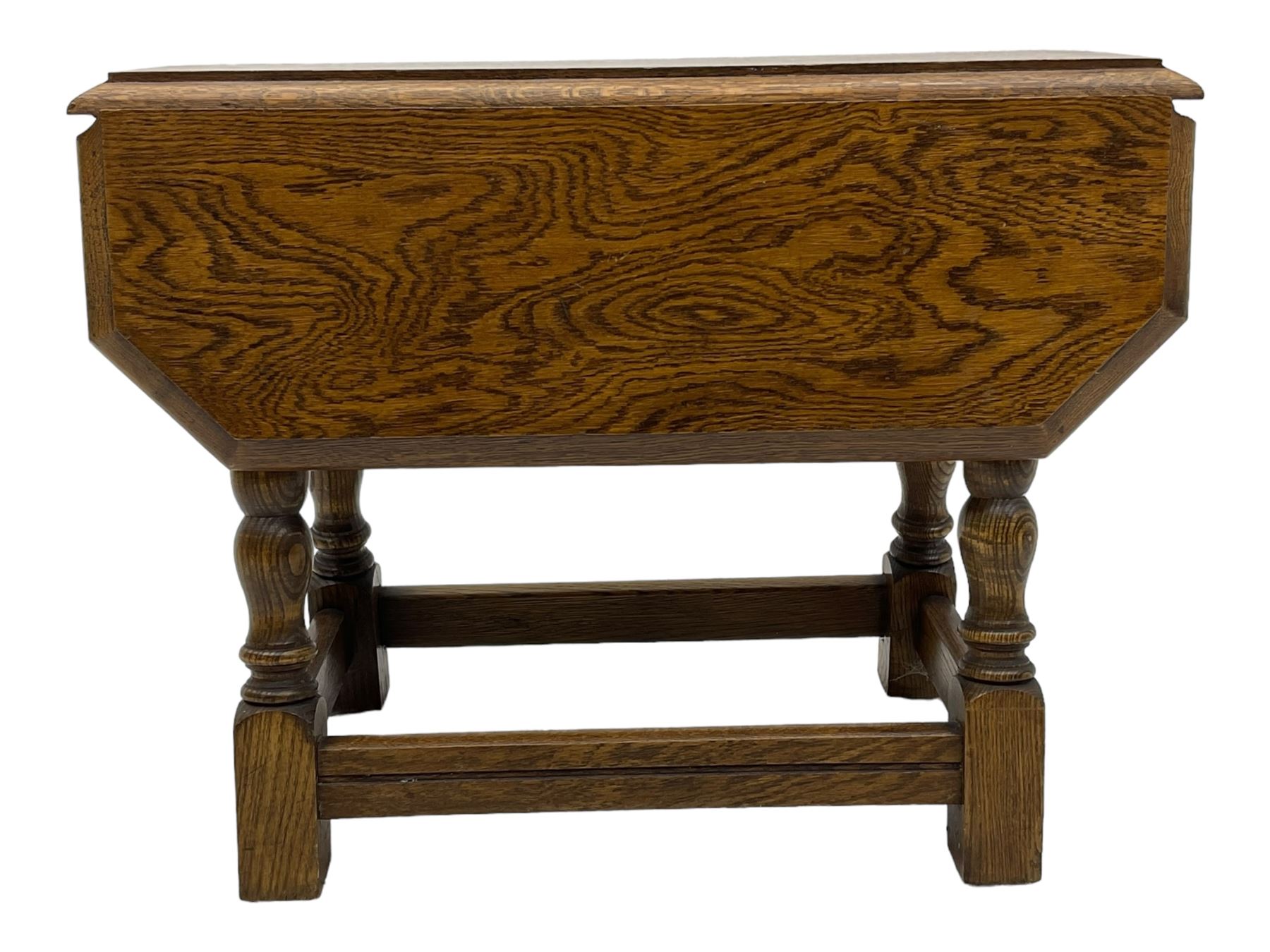 20th century oak drop-leaf table, bevel edged square top with cut corners, raised on splayed turned baluster supports united by stretchers