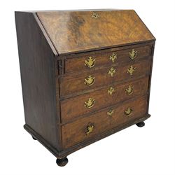 George I figured walnut bureau, hinged fall front enclosing drawers, pigeon holes and slide revealing storage well, fitted with four long cock-beaded and graduating drawers, shaped brass handle plates and escutcheons, on turned bun feet 