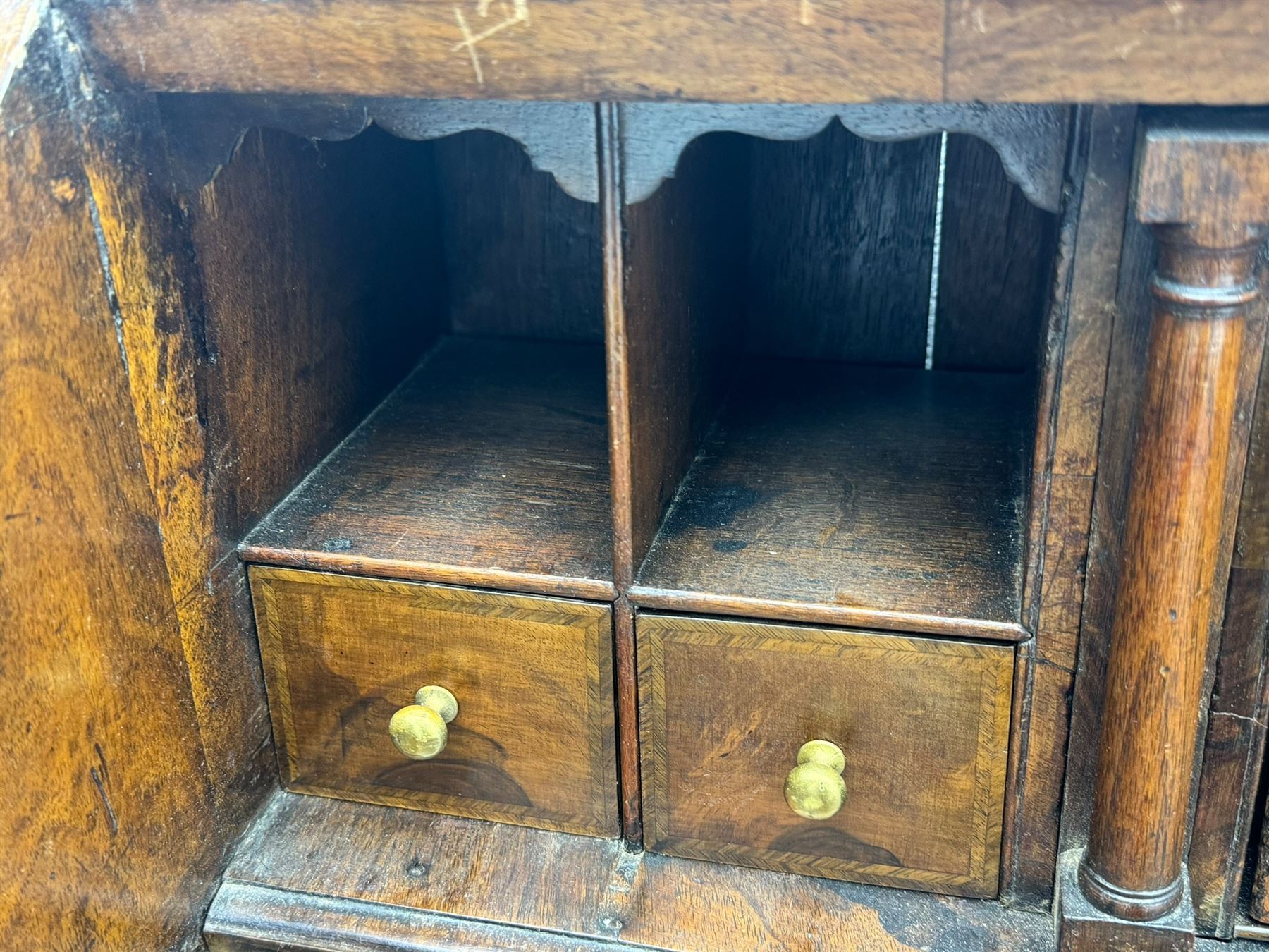 18th century walnut bureau, fall-front enclosing fitted interior with drawers and pigeonholes, over two short and two long drawers with brass escutcheon plates and handles, raised on bracket feet