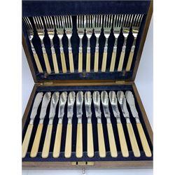 Victorian Aesthetic movement set of twelve desert knives and forks, with ivorine bamboo modelled handles, contained within a fitted case with mustard yellow plus and silk lined interior, together with a cased set of twelve fish knives and forks with ivorine handles and silver ferrules, and a cased pair of fish eaters with ivorine handles 