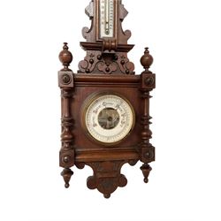 Early 20th century Edwardian aneroid barometer, in a mahogany case with scroll carving, turned finials and pendants, boxed mercury thermometer recording temperature in degrees Fahrenheit and centigrade on opaline register, open dial barometric register with gothic script predictions, steel indicating hand and brass recording hand.