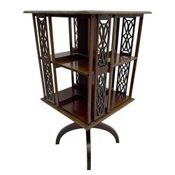 Edwardian mahogany revolving bookcase, square moulded top with satinwood band, two tiers with pierced vertical splats, on four curved supports 