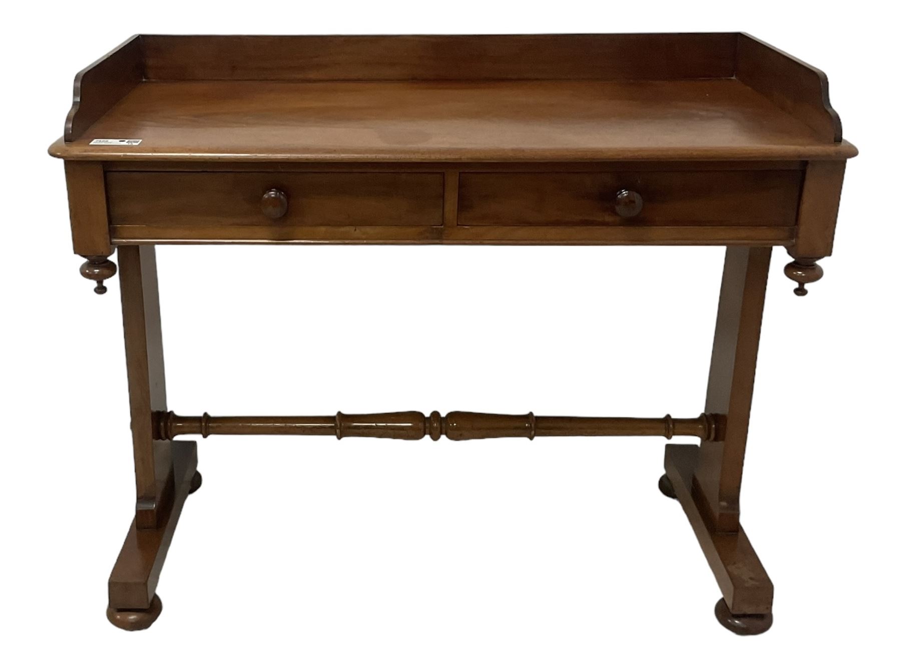 Victorian mahogany washstand, three-quarter raised gallery back, rectangular top with over two drawers, on shaped end supports united by ring-turned stretcher