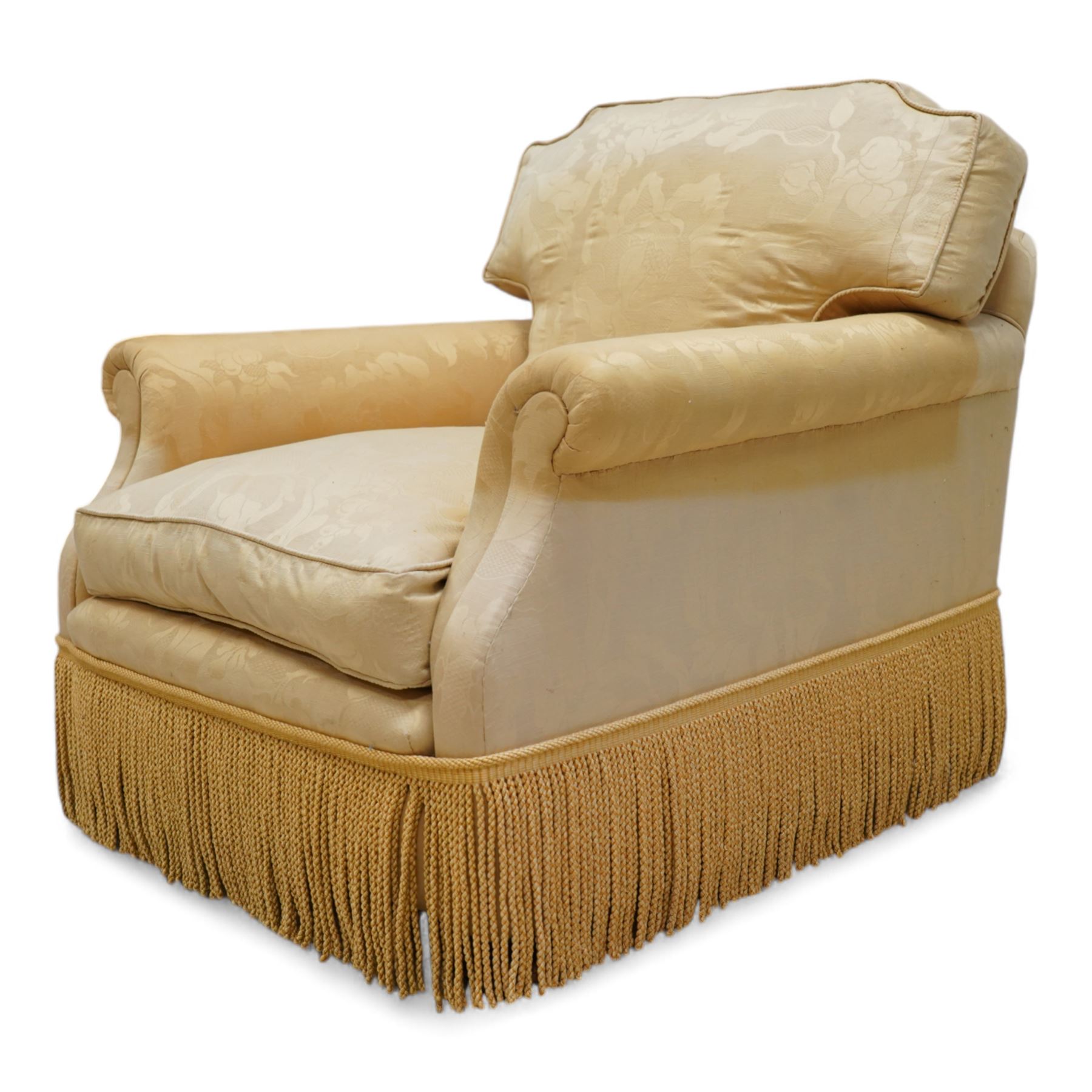 Early 20th century hardwood-framed armchair, shaped cresting over rolled arms, upholstered in floral pattern gold silk fabric with fringe, on turned front feet with recessed castors 