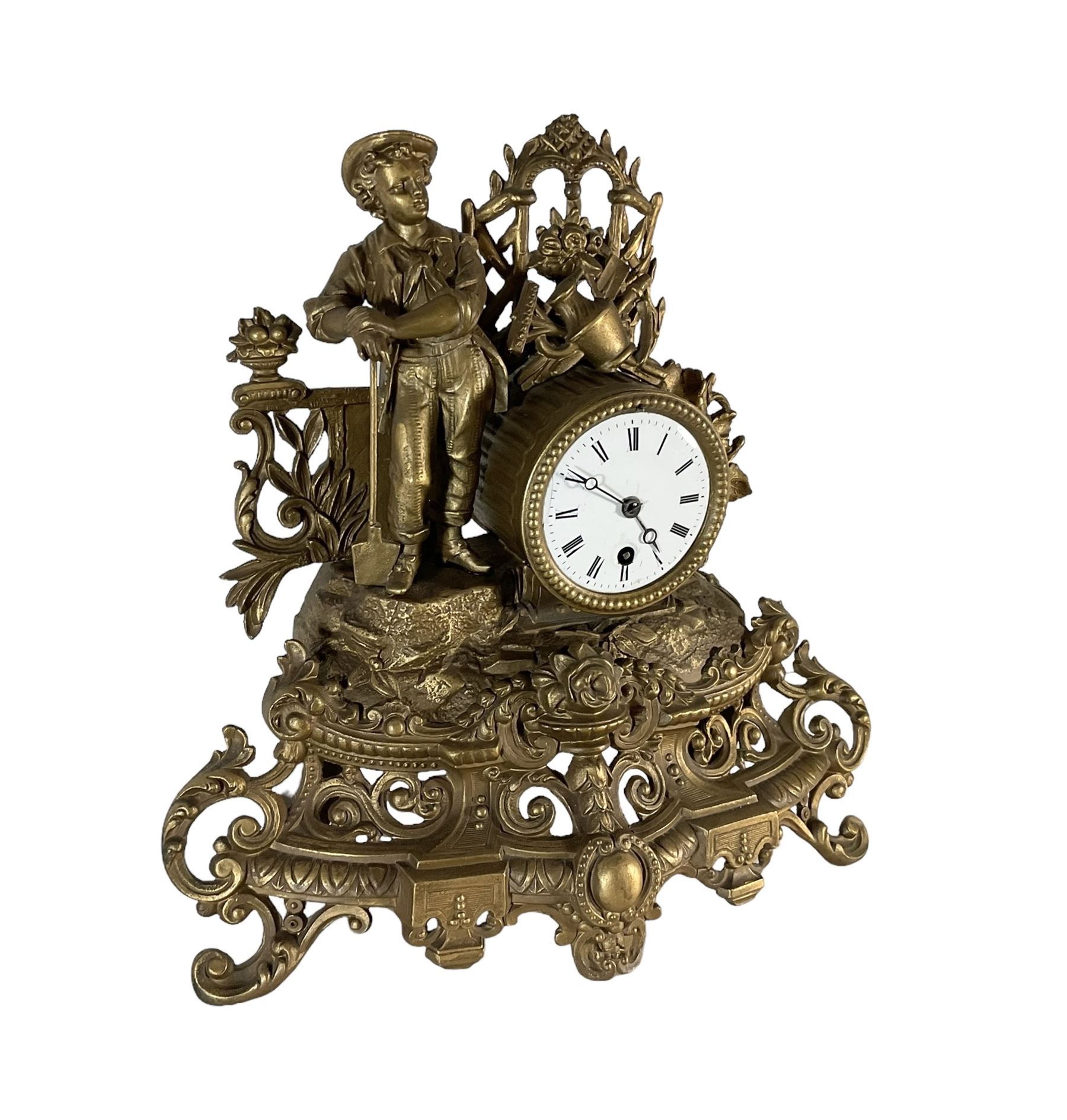 19th century - French gilt spelter 8-day timepiece mantle clock, with an ornate rococo case on splayed feet, drum movement with a cast figure of a gardener, flowers and gardening tools, white enamel dial with Roman numerals, minute markers and matching steel moon hands. With pendulum.   