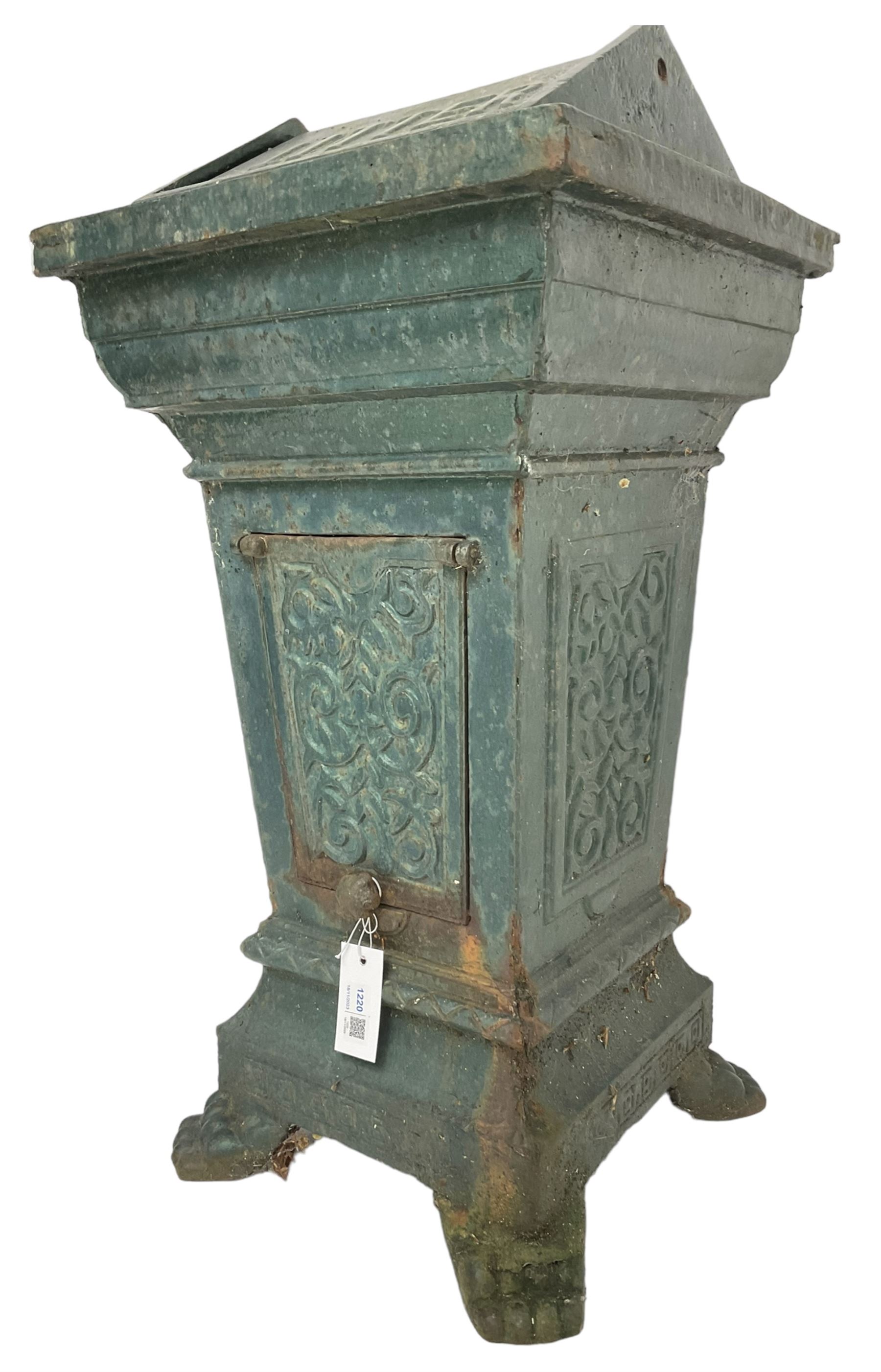 Early 20th century cast iron litter bin, square tapering form with scrolling foliate decoration, on paw feet