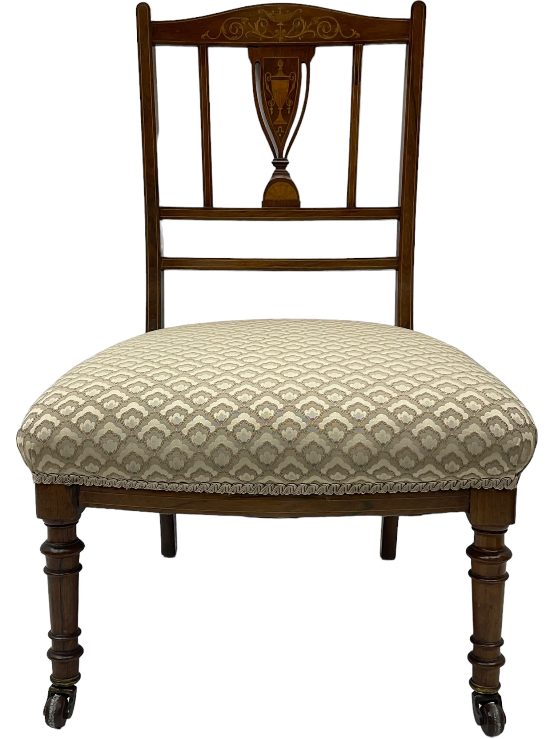 Early 20th century mahogany side chair, detailed marquetry frame, backrest with central urn motif and scrollwork inlay, arched crest rail with floral designs, cream and gold patterned fabric seat, turned front legs with brass castors (H78cm); Victorian walnut nursing chair, carved crest rail, floral needlepoint tapestry upholstery, turned front legs with ceramic castors (H81cm)