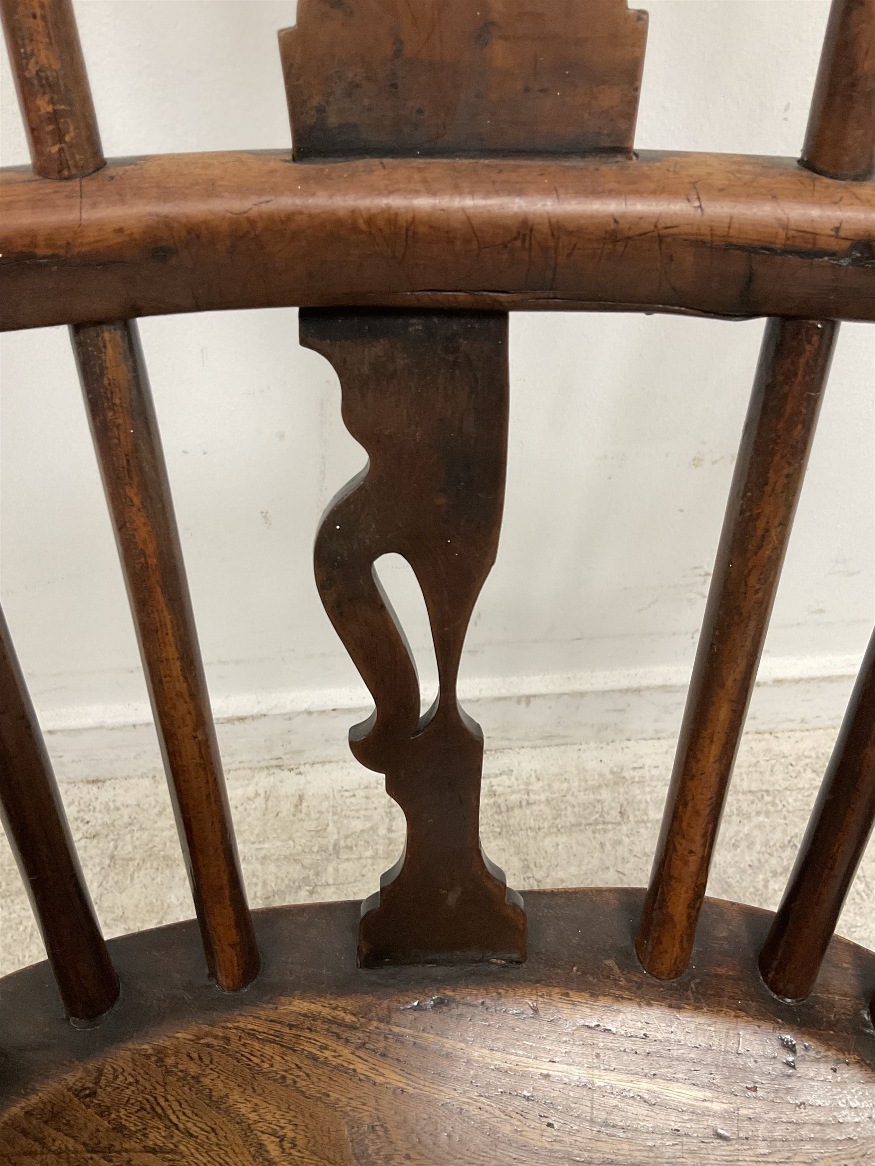 19th century yew wood and elm Windsor chair, low hoop stick back with pierced splat, dished seat raised on ring turned supports joined by crinoline stretcher