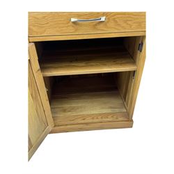 Contemporary light oak twin pedestal desk, fitted with three drawers over two cupboards with chrome handles, the central drawer with hinged front panel revealing pull-out keyboard tray, on plinth base