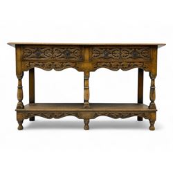 17th century design oak dresser base, rectangular top above two drawers with carved foliat...