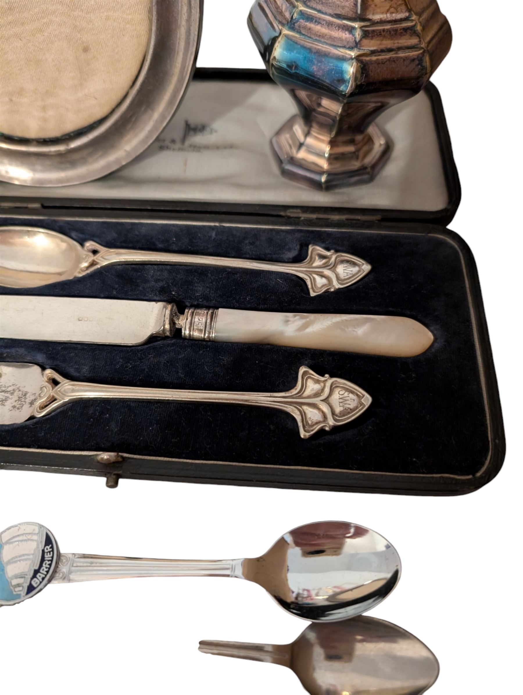 Silver photograph frame and a silver mustard spoon, both hallmarked, together with an Egyptian silver box, silver plated Walker & Hall christening set, silver plated sugar caster, silver plated coffee bean spoons, and silver plated pepper and salt shaker