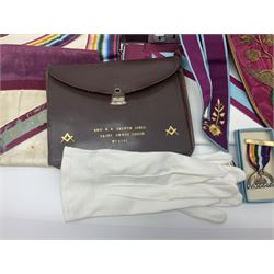 Masonic regalia, including two silver-gilt medals/jewels, centenary medal, aprons, and sash etc, housed in brown briefcase